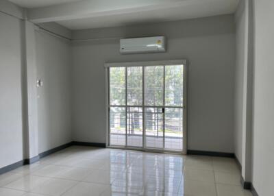 Spacious living room with large window and air conditioning