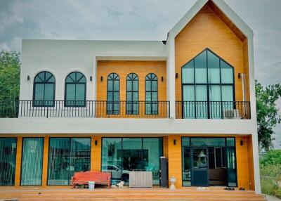 Modern two-story house with large windows and balcony