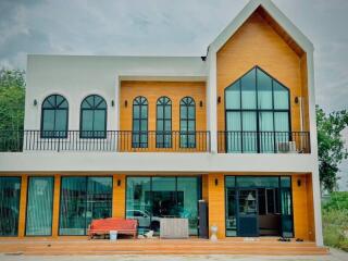 Modern two-story house with large windows and balcony