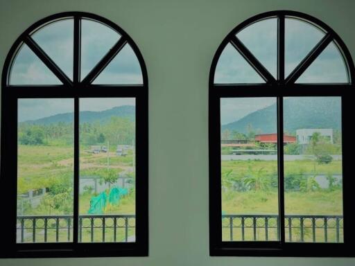 View through large arched windows overlooking scenic landscape