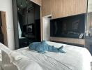 Modern bedroom with wall-mounted TV and air conditioner