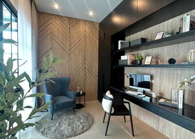 Modern home office with built-in shelves and seating area