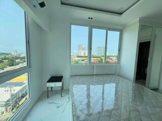 Bedroom with large windows and city views