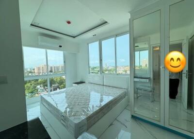 Spacious bedroom with large windows and city view