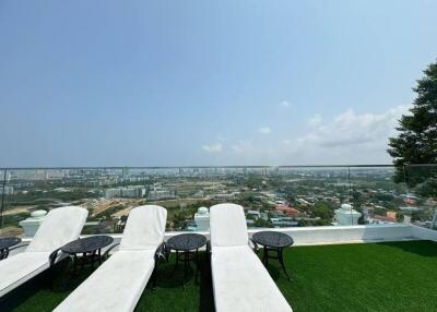 Outdoor terrace with lounge chairs and city view