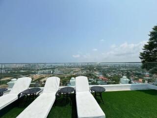 Outdoor terrace with lounge chairs and city view