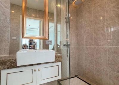 Modern bathroom with glass shower and marble sink countertop