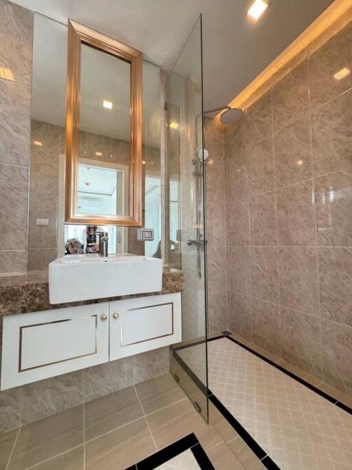 Modern bathroom with glass shower and marble sink countertop