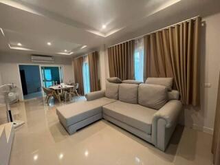 Spacious living room with sectional sofa and modern dining area