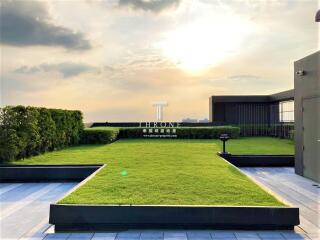 Sunset on rooftop garden with manicured lawn