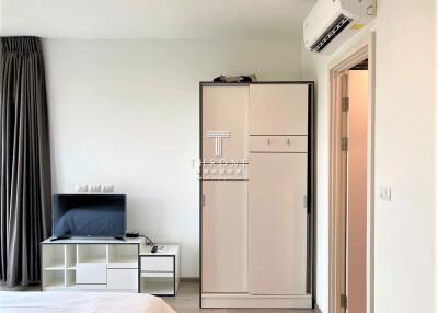 Modern bedroom with wardrobe, TV, and air conditioning