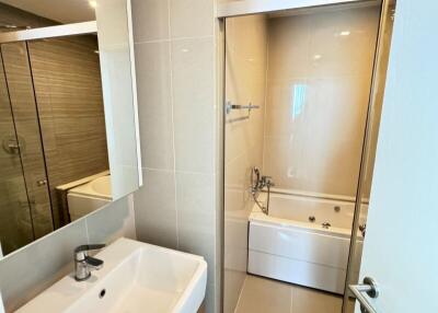 Modern bathroom with sink, mirror, and bathtub