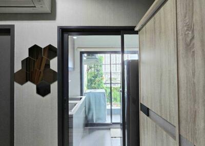 View into kitchen with modern appliances and sliding glass door