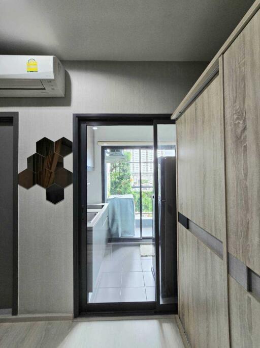 View into kitchen with modern appliances and sliding glass door