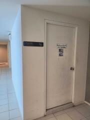Building hallway with janitorial room door