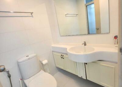 Modern bathroom with white fixtures and large mirror