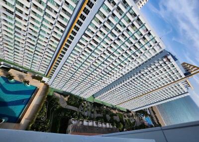 Tall apartment buildings with pool and sea view