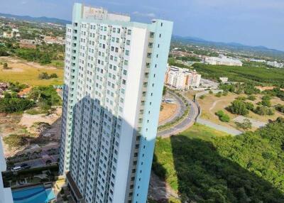 High-rise residential building with surrounding greenery