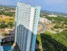 High-rise residential building with surrounding greenery