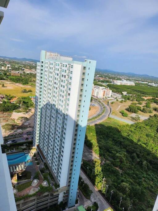 High-rise residential building with surrounding greenery