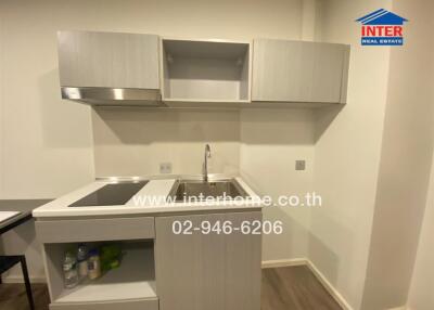 Modern kitchen with a sink, stovetop, and cupboards