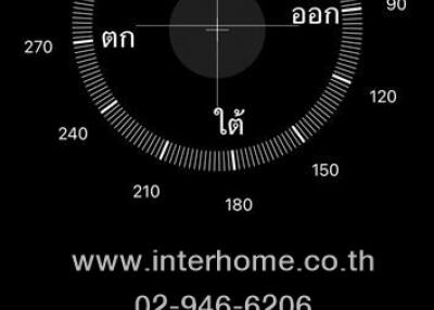 Screenshot featuring a compass with a contact number and website of a real estate agency