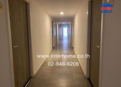 Apartment hallway with doors and tile flooring