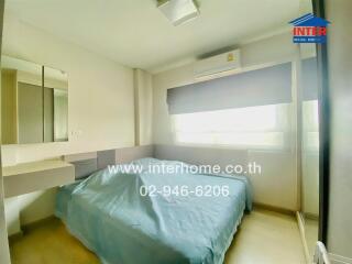 Main bedroom with bed, mirror, and air conditioning