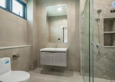 Modern bathroom with glass shower enclosure and wall-mounted vanity