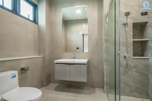 Modern bathroom with glass shower enclosure and wall-mounted vanity