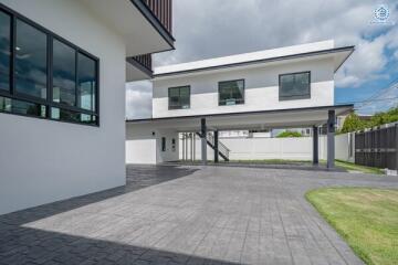 Modern two-story house with large windows and driveway