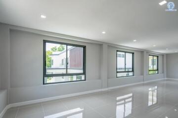 Spacious living area with large windows and ample natural light