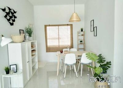 Modern dining room with white furniture and decorative elements