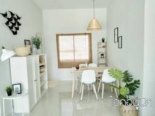 Modern dining room with white furniture and decorative elements