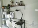 Home office with desk, chair, lamp, shelf, and decorations