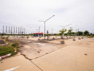 Outdoor parking area with light poles and small trees