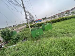 Outdoor area with green grass and electrical poles