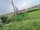 Outdoor area with green grass and electrical poles