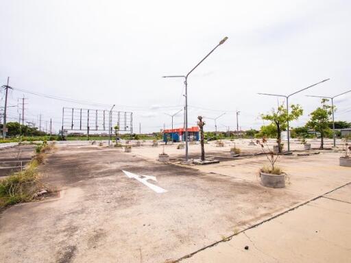 Spacious outdoor parking area with multiple parking spots and street lighting