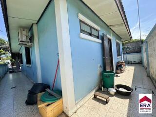 Outdoor view of the blue house with various items placed around