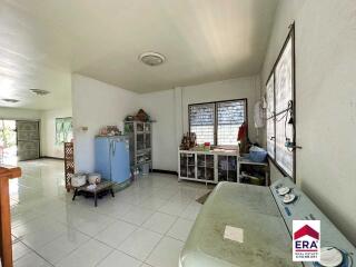 Spacious kitchen with storage units and large windows