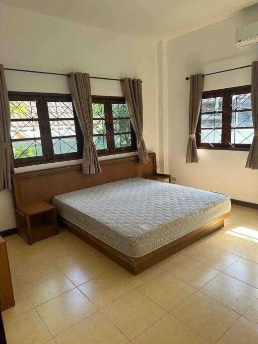 Spacious bedroom with large windows and a double bed