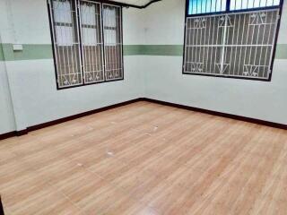 Unfurnished bedroom with tiled floors and barred windows