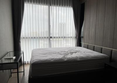 Modern bedroom with large window and curtains