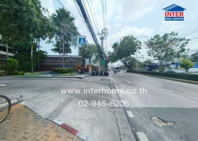 Street view with nearby buildings and greenery