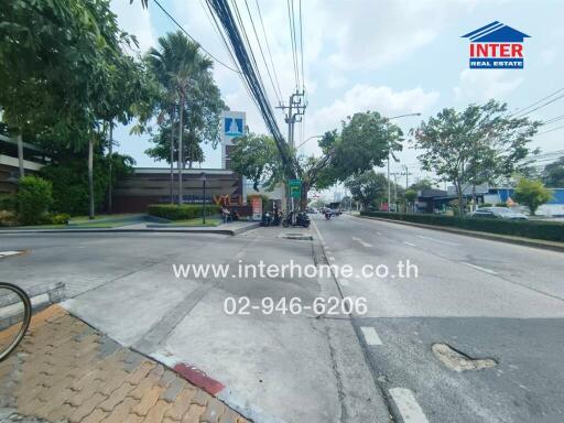 Street view with nearby buildings and greenery