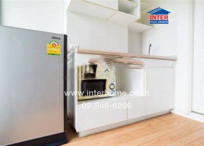 Modern kitchen with fridge and cabinets