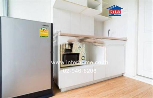 Modern kitchen with fridge and cabinets