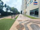 Exterior view of the building's pathway with nearby fitness equipment