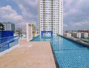 Modern high-rise building with a rooftop infinity pool